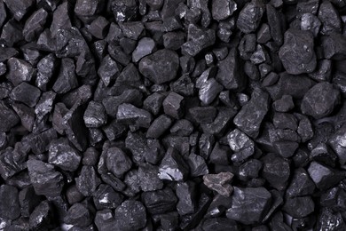 Pieces of black coal as background, top view