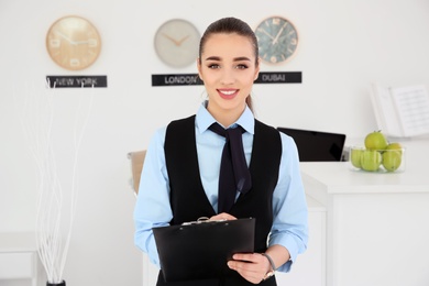 Portrait of female receptionist at workplace in hotel