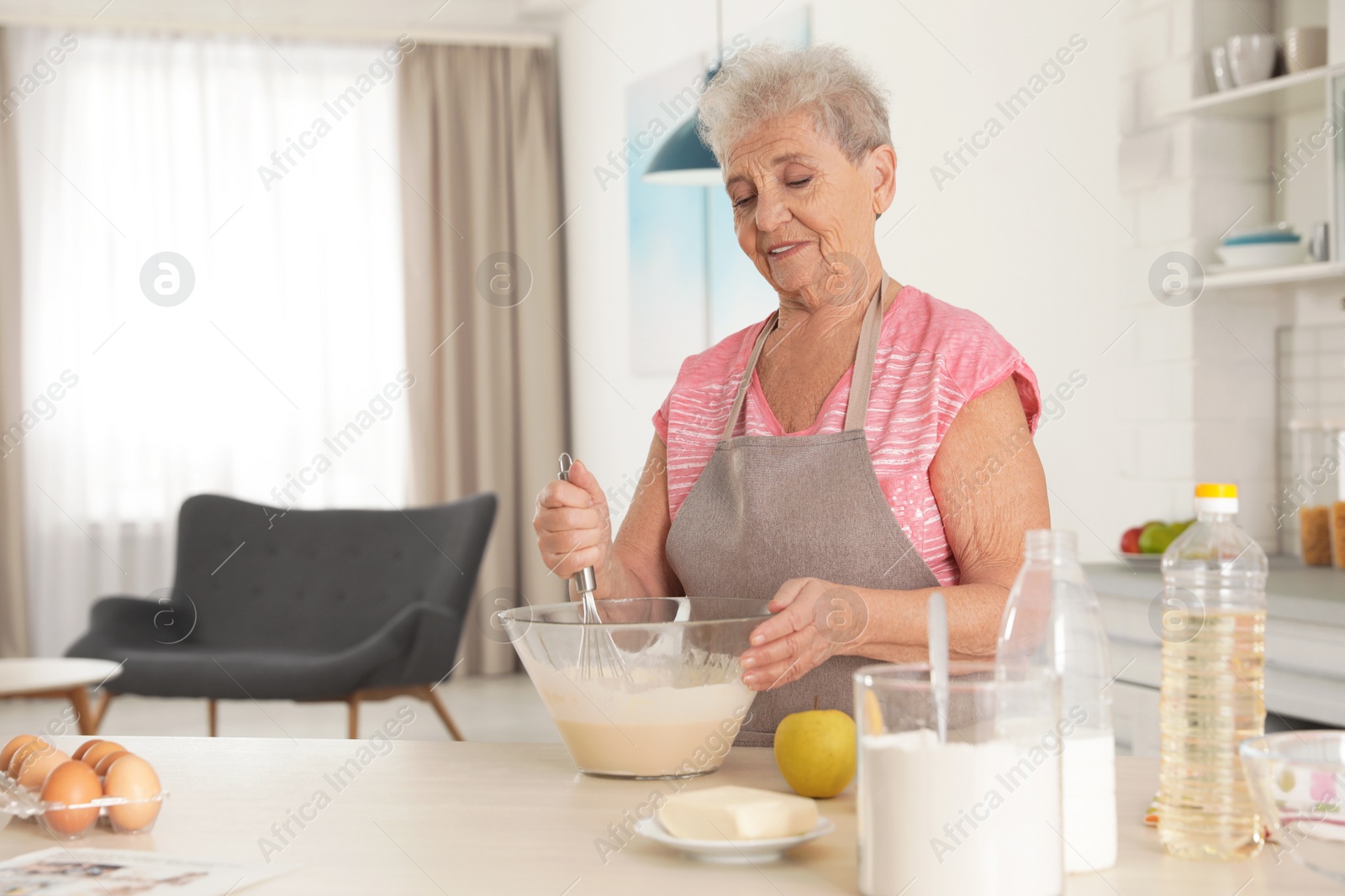 Photo of Portrait of beautiful grandmother cooking in kitchen