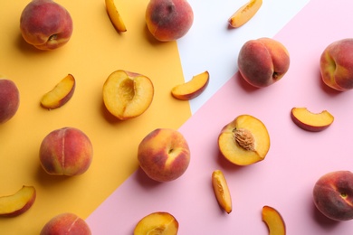 Photo of Flat lay composition with fresh peaches on color background