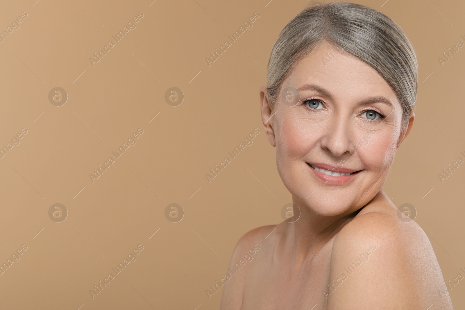 Photo of Beautiful mature woman with healthy skin on beige background, space for text