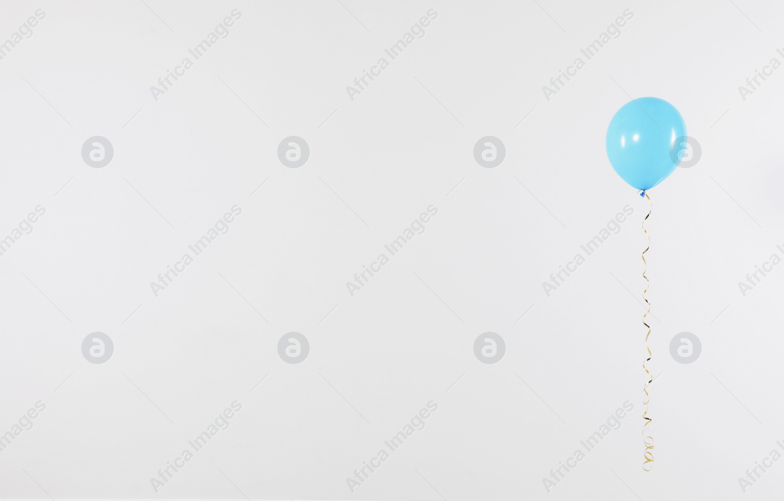 Photo of Bright balloon on light background, space for text. Celebration time