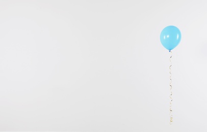 Photo of Bright balloon on light background, space for text. Celebration time