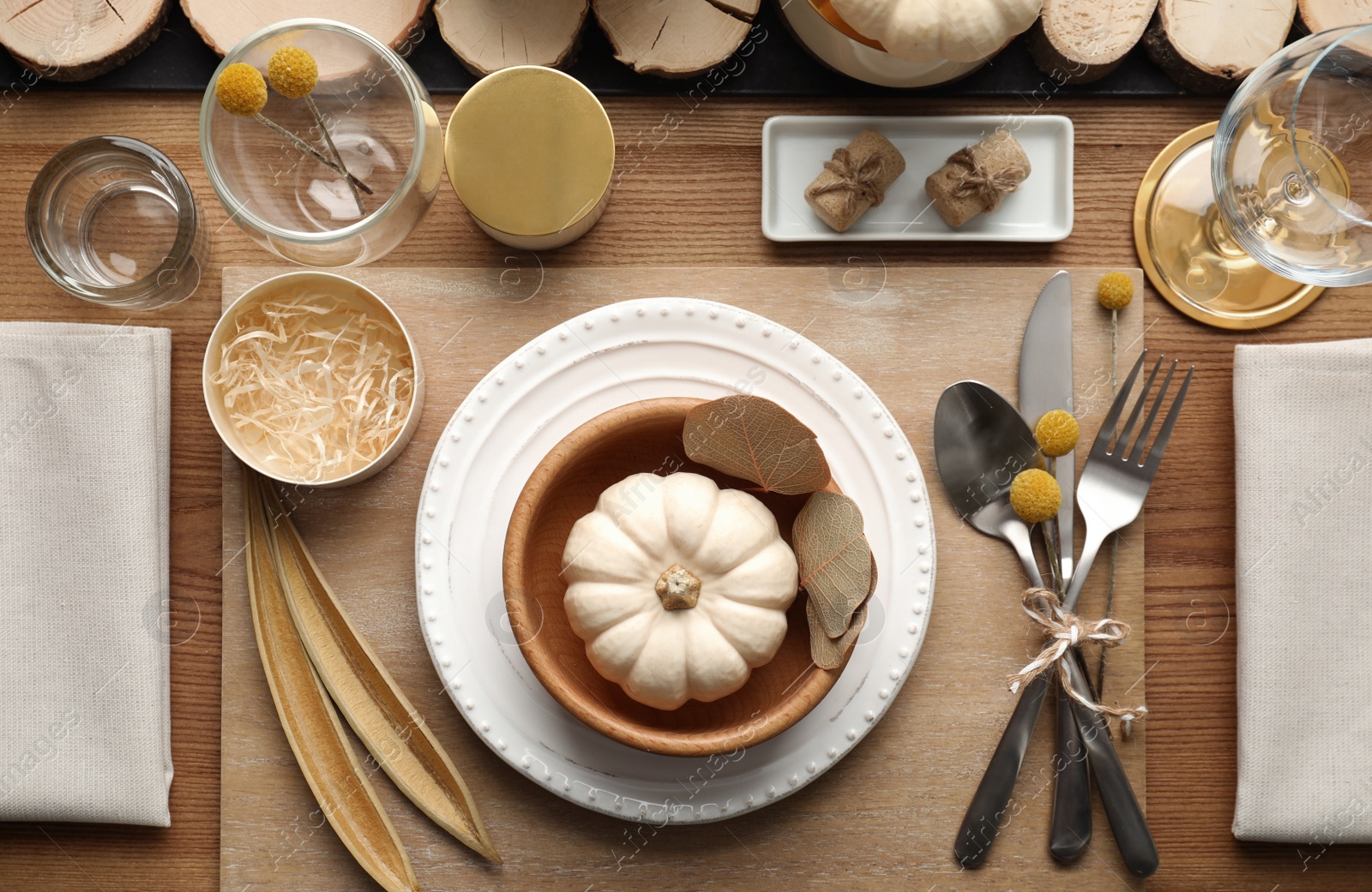 Photo of Autumn table setting with pumpkin and decor on wooden background, flat lay