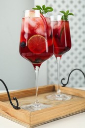 Photo of Delicious Red Sangria with fruits on white wooden table