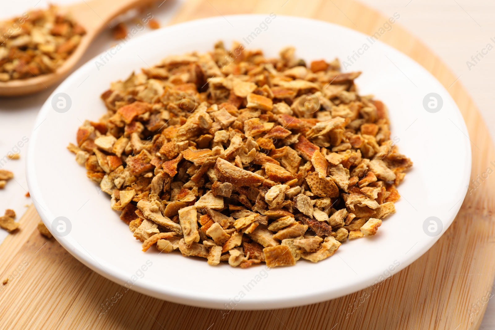 Photo of Plate with dried orange zest seasoning on plate, closeup