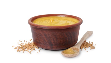 Photo of Fresh tasty mustard sauce in bowl, spoon and dry seeds isolated on white