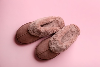 Pair of stylish soft slippers on pink background, flat lay