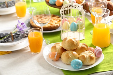 Festive Easter table setting with traditional meal at home, space for text