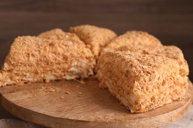 Pieces of delicious Napoleon cake on board, closeup