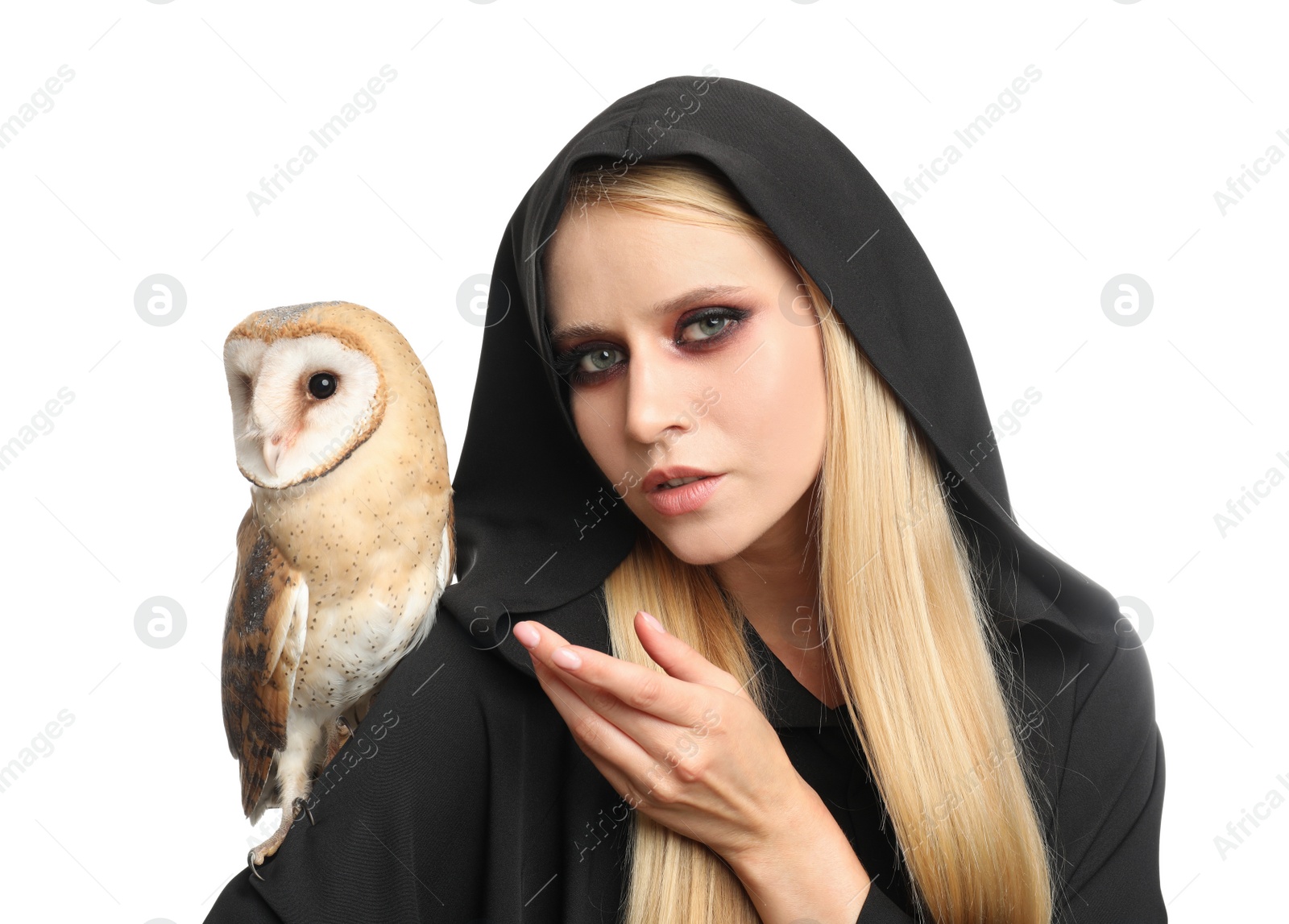 Photo of Witch in black mantle with owl isolated on white. Scary fantasy character