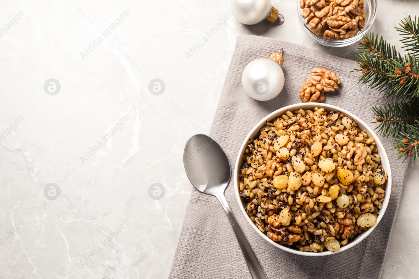 Photo of Traditional Christmas slavic dish kutia served on grey marble table, flat lay. Space for text