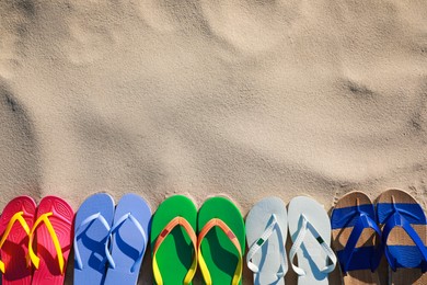 Stylish flip flops on beach, flat lay. Space for text