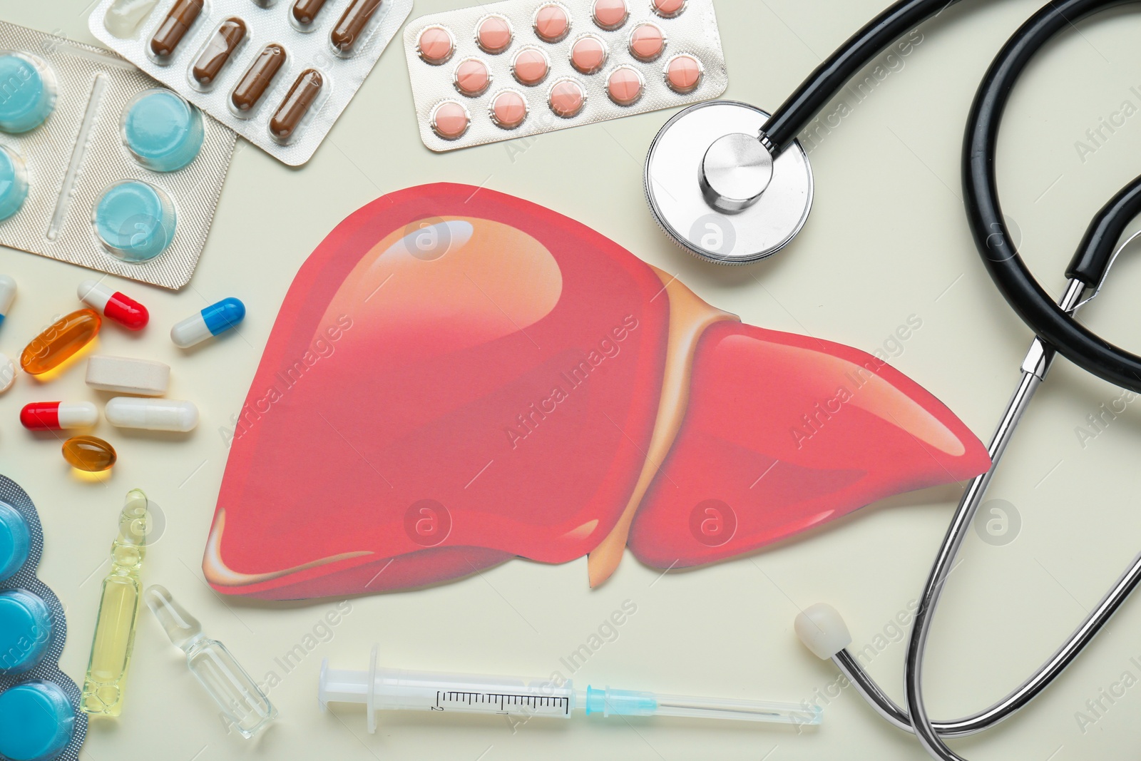 Photo of Paper liver and medical supplies on beige background, flat lay. Hepatitis treatment