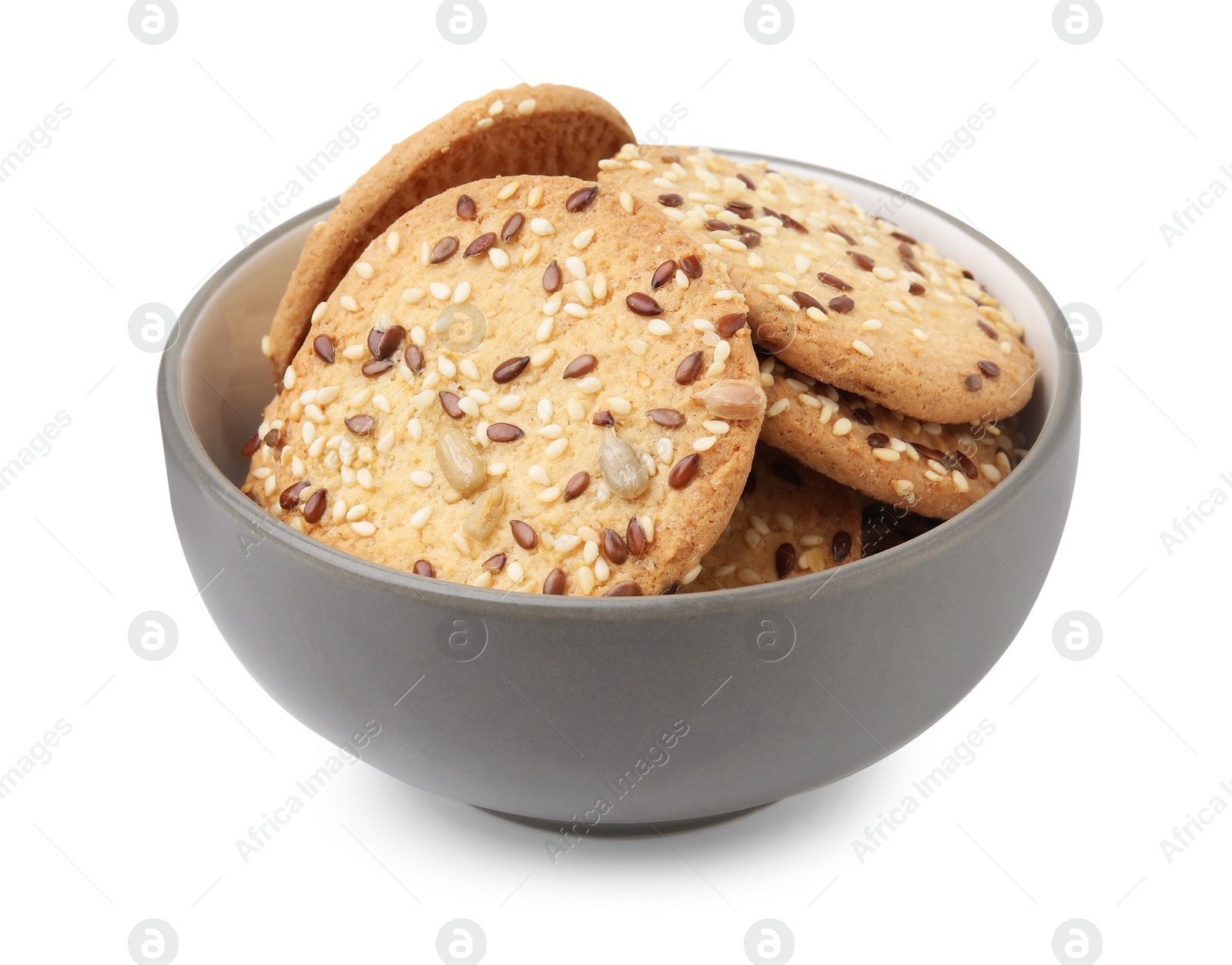 Photo of Round cereal crackers with flax, sunflower and sesame seeds in bowl isolated on white