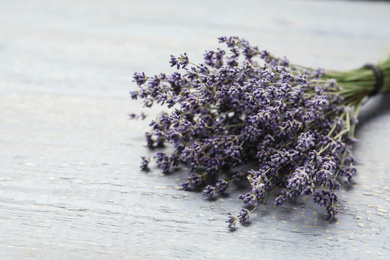 Dried lavender flowers on grey wooden table, closeup