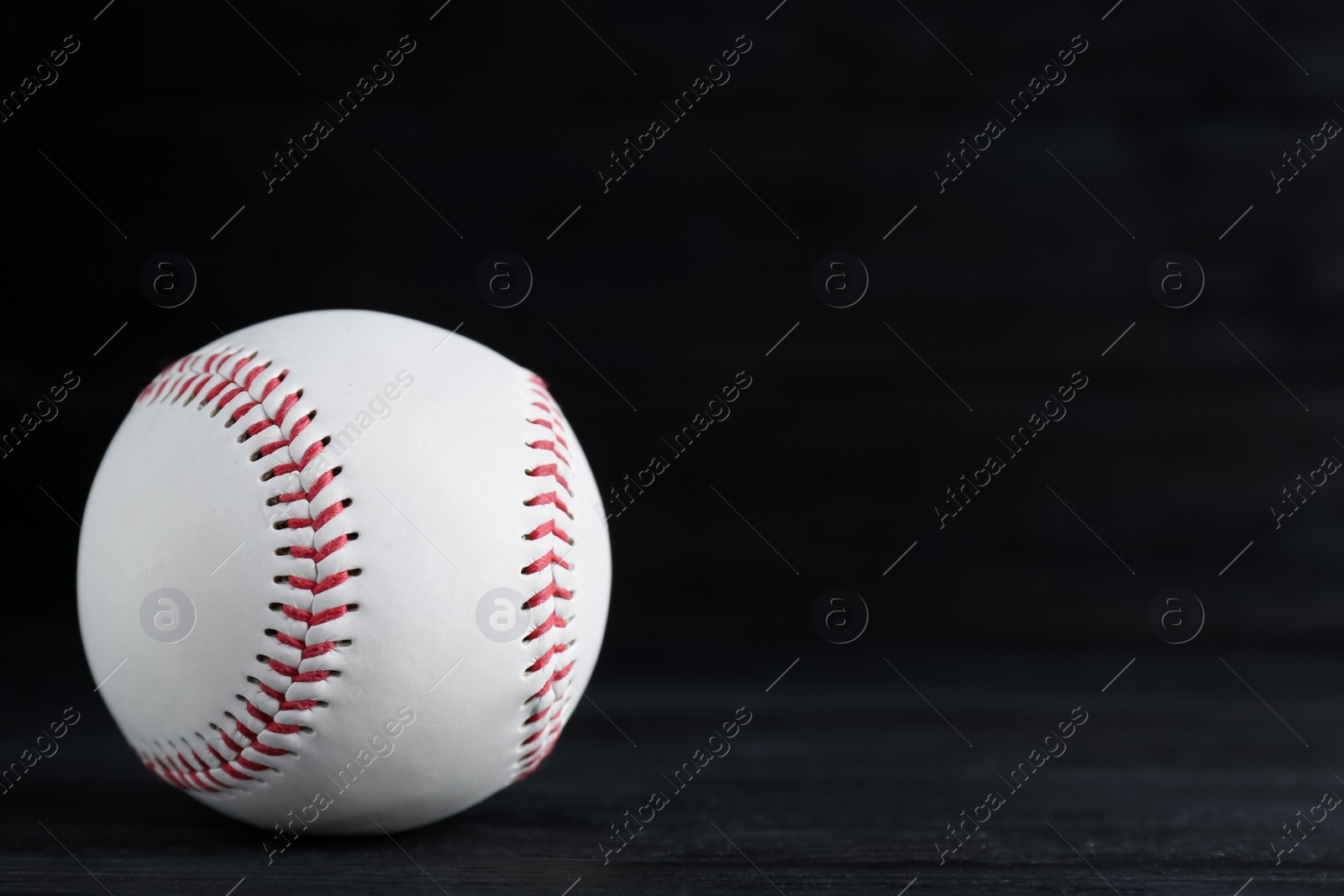 Photo of Baseball ball on black background, space for text. Sports game