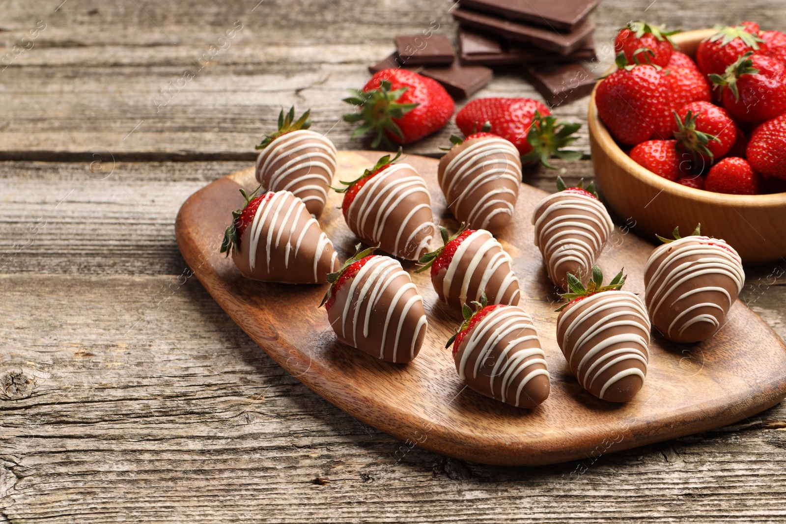 Photo of Delicious chocolate covered strawberries on wooden table. Space for text