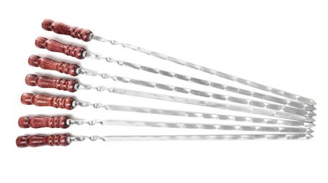 Photo of Metal skewers with wooden handle on white background, top view
