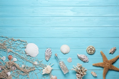 Photo of Flat lay composition with seashells and space for text on wooden background