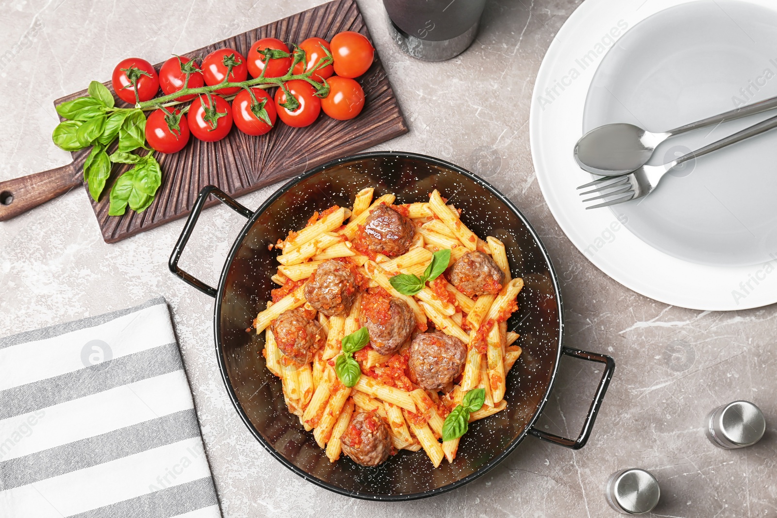 Photo of Pasta with meatballs and tomato sauce on grey background