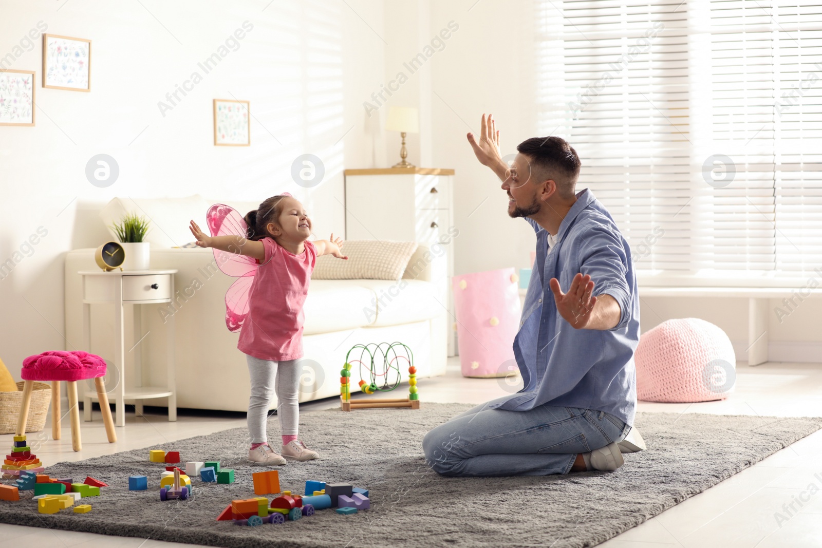 Photo of Father playing with his child at home