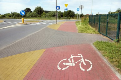 Photo of Red bicycle lane on pavement along road