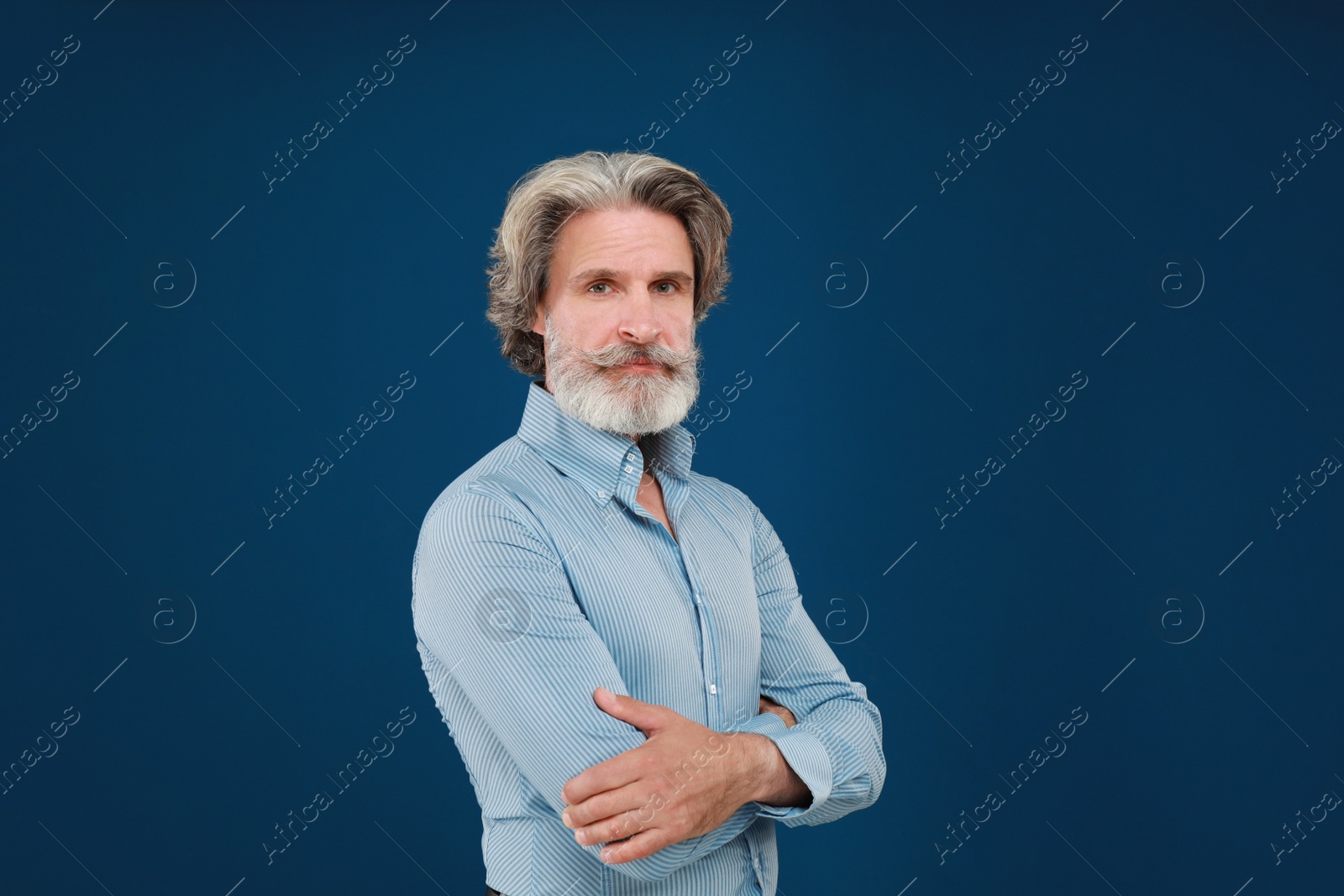 Photo of Portrait of handsome mature man on blue background