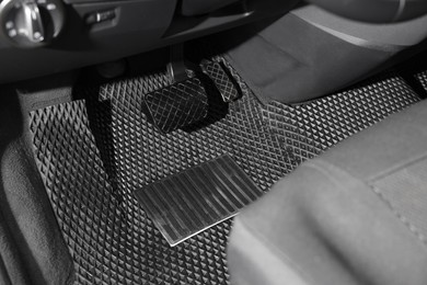 Photo of Black rubber car floor mat in auto