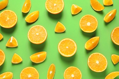 Flat lay composition with ripe oranges on color background