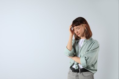 Portrait of stressed young girl on white background. Space for text