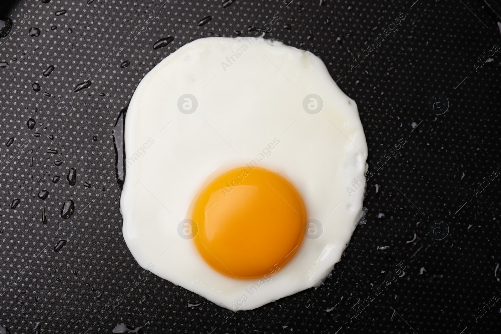Photo of Tasty fried egg in pan, top view