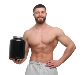 Young man with muscular body holding jar of protein powder on white background