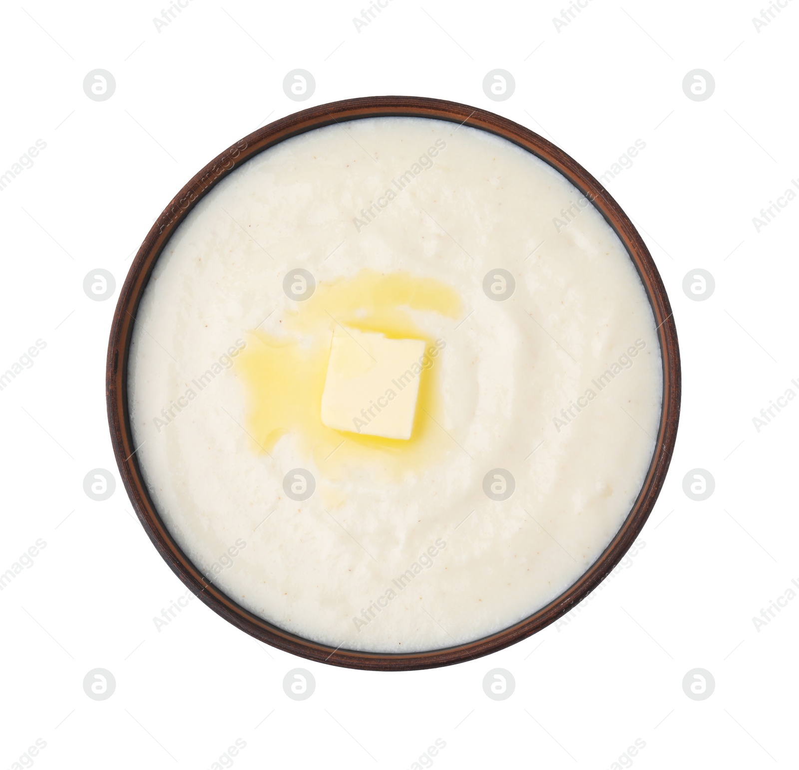 Photo of Delicious semolina pudding with butter in bowl isolated on white, top view