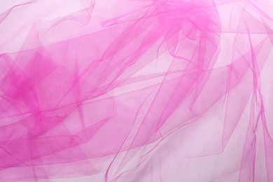 Photo of Beautiful pink tulle fabric on white background, top view
