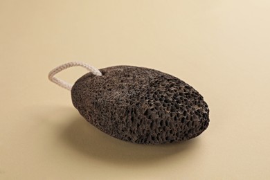 Pumice stone on beige background. Pedicure tool