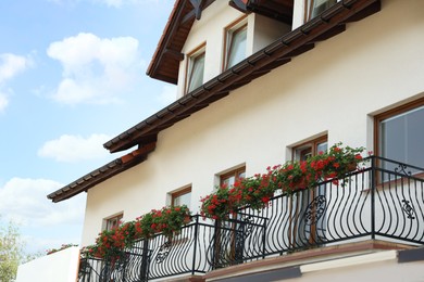 Photo of View of house with flowers on balcony railings