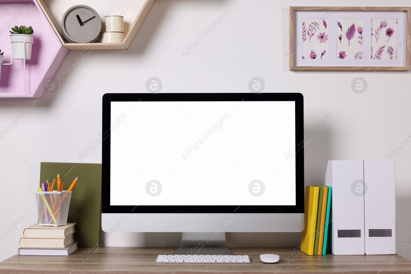 Photo of Cozy workspace with modern computer and stationery on wooden desk