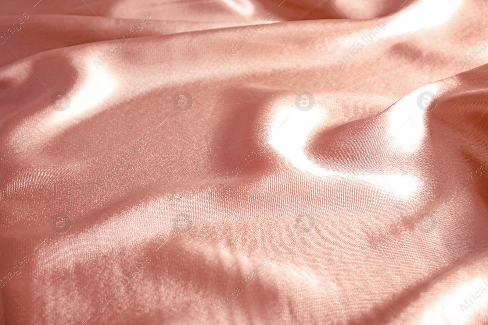 Photo of Texture of rose gold silk as background