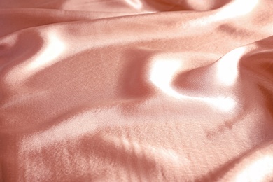 Photo of Texture of rose gold silk as background