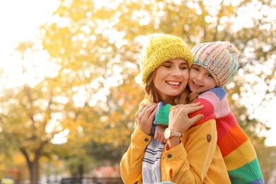 Photo of Mother with her cute daughter spending time together in park. Autumn walk