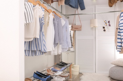 Modern dressing room with different stylish clothes and accessories