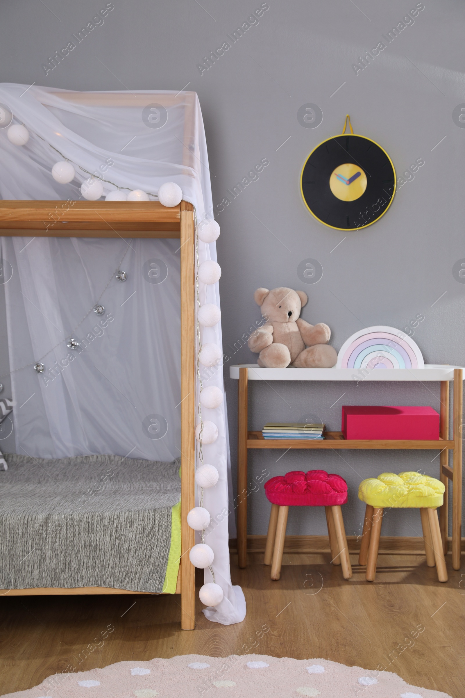 Photo of Stylish child room interior with comfortable house bed