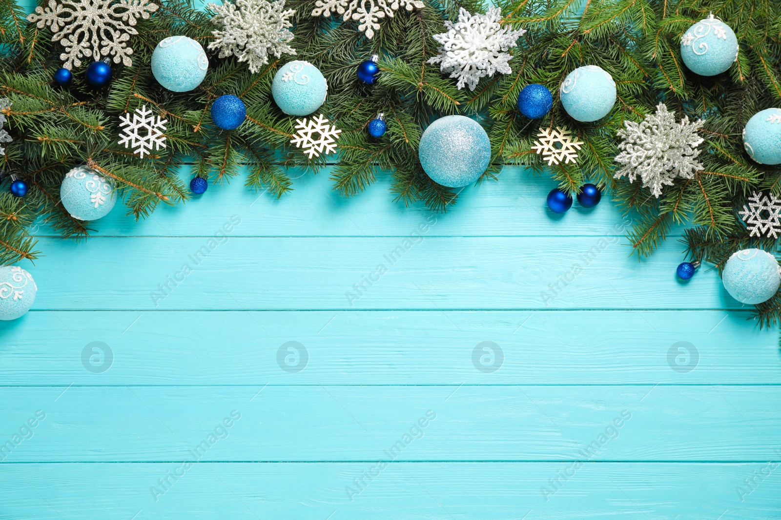 Photo of Fir branches with Christmas decoration on light blue wooden background, flat lay. Space for text