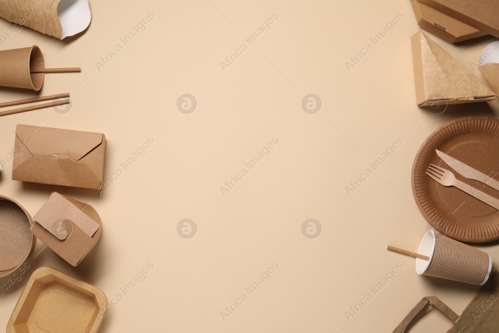 Photo of Eco friendly food packaging. Paper containers and tableware on beige background, flat lay. Space for text