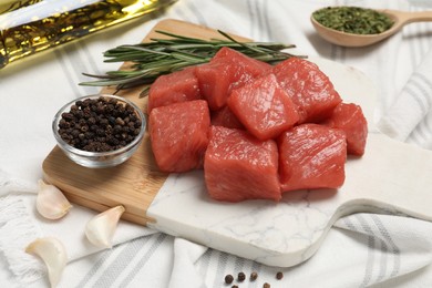 Raw beef meat and different ingredients for cooking delicious goulash on table, closeup