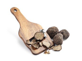 Photo of Wooden shaver with whole and sliced black truffles on white background