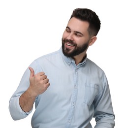 Happy young man with mustache pointing at something on white background