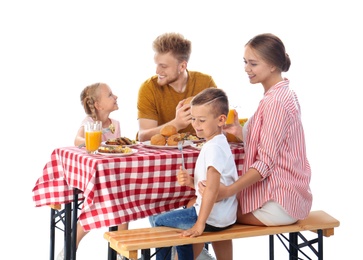 Photo of Happy family having picnic at table on white background