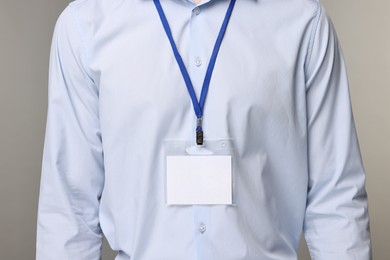 Photo of Man with empty badge on grey background, closeup